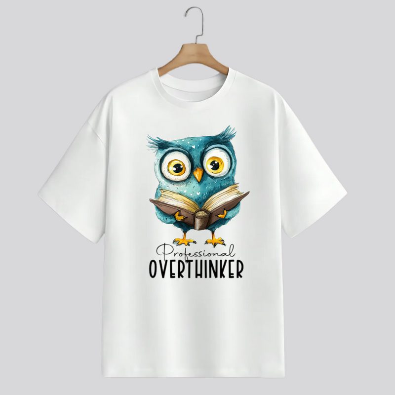 White t-shirt with an owl graphic and 'Professional Overthinker' text on a hanger against a white background